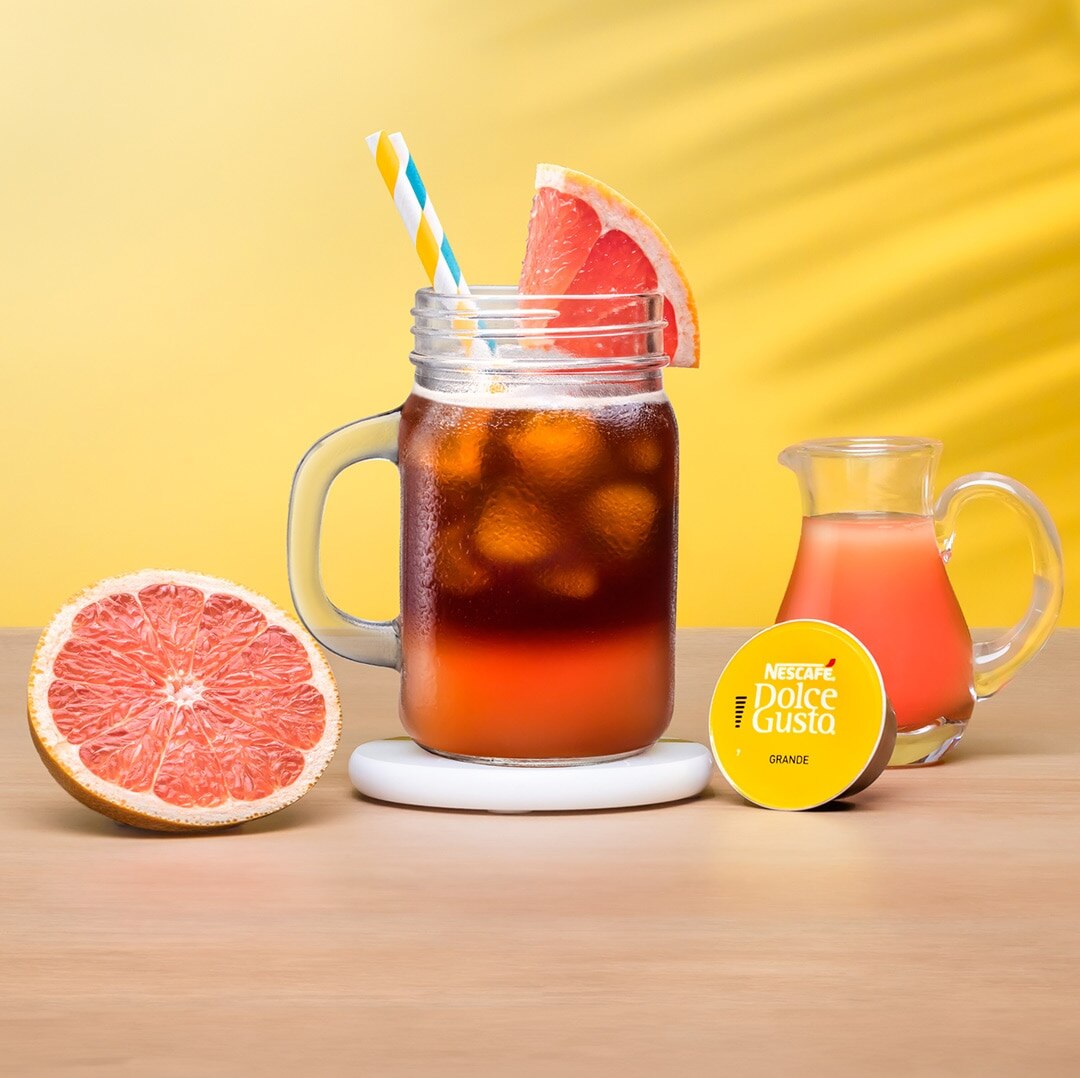 iced grapefruit next to a coffee capsule